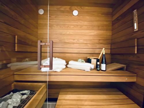 a sauna with towels and bottles of wine at Strandvilla Charlotte Binz in Binz