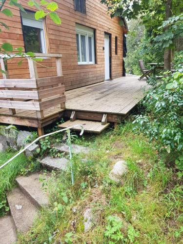 a wooden deck in front of a house at Appartement cosy calme à l'orée du bois in Cornimont