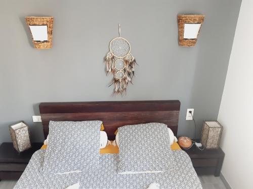 a bedroom with a bed and two pictures on the wall at Chambres Privées " Les Pins " in Béziers