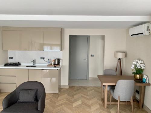 a kitchen and dining room with a table and chairs at Istanbul Park Hotel in Tuzla