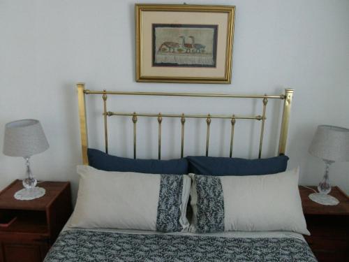 a bedroom with a bed with blue and white pillows at Casa Bianco in Montagu