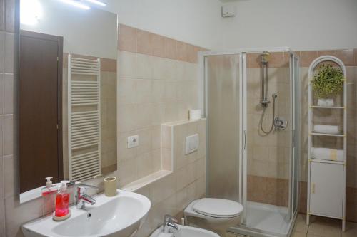 a bathroom with a toilet and a sink and a shower at Bellagio Villas in Lezzeno