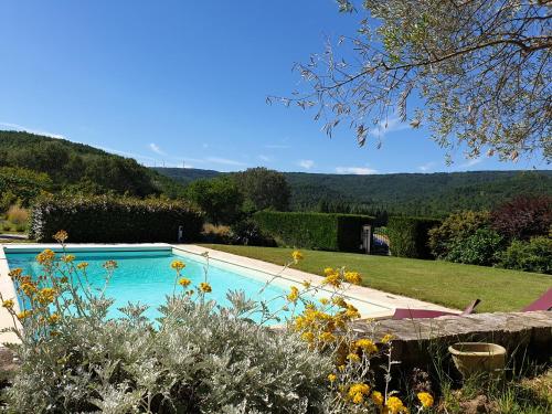 a swimming pool with a view of a garden at Les Genêts de la Valdaine in Rochefort-en-Valdaine
