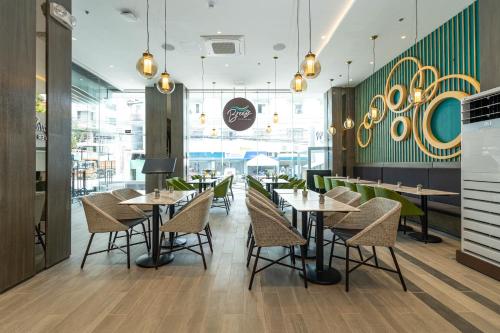 a dining room with tables and chairs in a restaurant at Bayfront Hotel Cebu Capitol Site in Cebu City