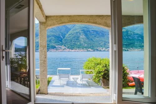 a view of the water from a house door at Bellagio Villas in Lezzeno