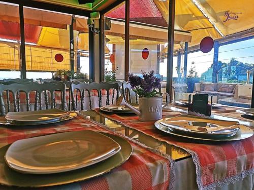 a table with plates and napkins on top at Hotel Campos de Baeza in Baeza