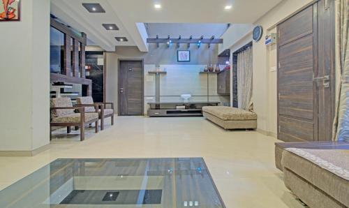 a living room with a glass table in a room at Treebo Sumati Baner in Pune