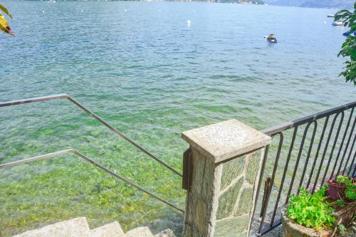 a view of a body of water with people in the water at Bellagio Villas in Lezzeno