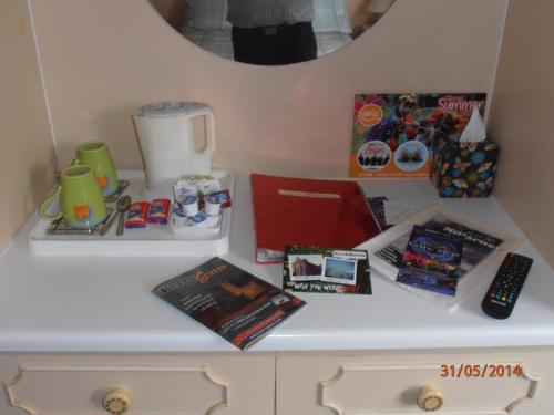 a desk with books and other items on it at Larkfield House B&B, Ballycasheen Kerry V93 WD51 in Killarney