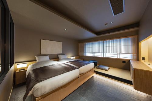 Postel nebo postele na pokoji v ubytování hotel tou nishinotoin kyoto