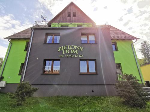 a building with a sign on the side of it at Zielony Dom in Bolesławiec