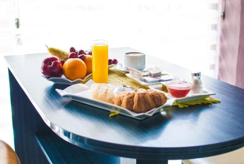 a tray of food on a table with fruit and juice at Reino de Granada in Granada