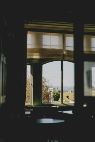 a window in a room with a view of a building at The Queens Hotel in Portsmouth