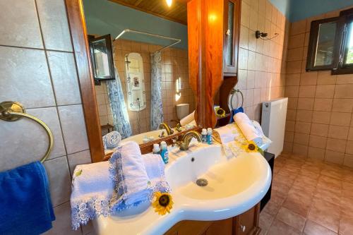 a bathroom with a sink and a mirror at Villa Vicky Corfu in Agios Ioannis