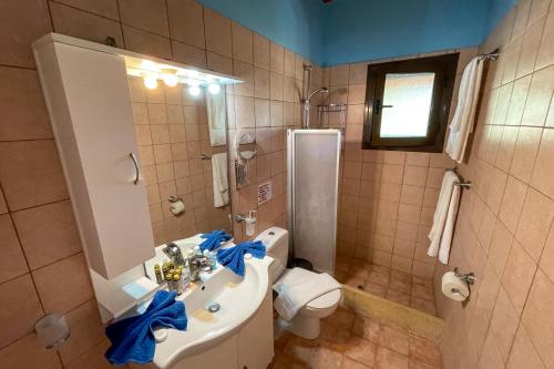 a bathroom with a sink and a toilet at Villa Vicky Corfu in Agios Ioannis