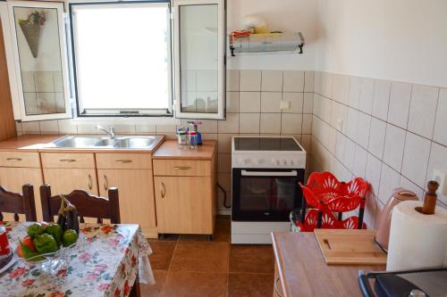 a kitchen with a sink and a stove top oven at Villa Vicky Corfu in Agios Ioannis