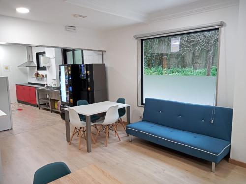 a living room with a blue couch and a table at A Fonte De Compostela in Santiago de Compostela