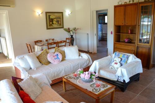 a living room with two couches and a coffee table at Villa Vicky Corfu in Agios Ioannis