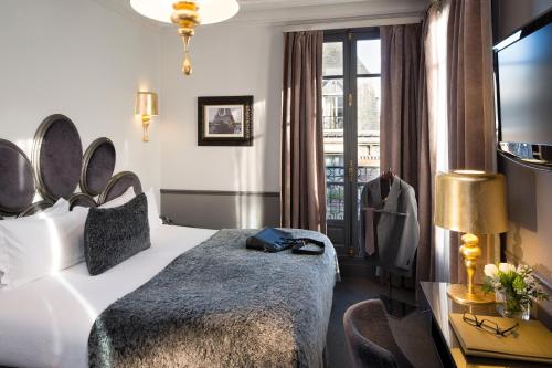 pokój hotelowy z łóżkiem i oknem w obiekcie Hotel Lumen Paris Louvre w Paryżu