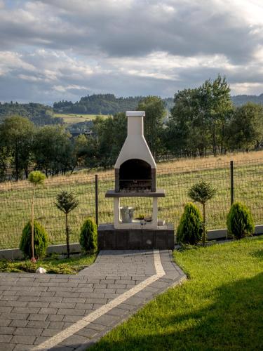 a fireplace in the middle of a field at OSADA Rokicie in Kluszkowce