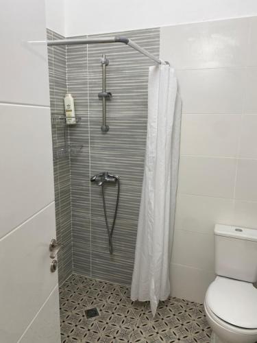 a bathroom with a shower with a toilet at Laila's studio2 in Haifa