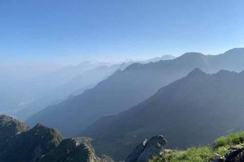 a view of a mountain range with a body of water at L'Oasi nel Borgo in Niardo