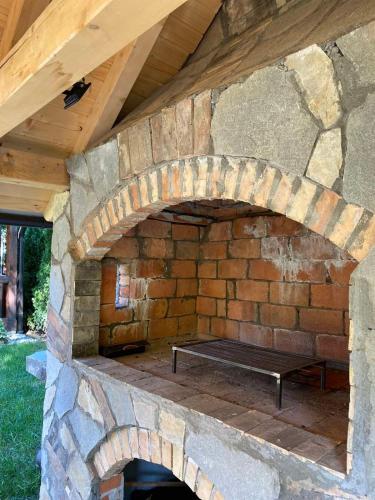 a stone oven with a bench sitting inside of it at Brvnare Ala Vrdnik in Vrdnik