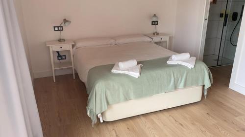 a bedroom with a bed with two towels on it at Casa Rural Al Otro Lado del Mar in Oviñana