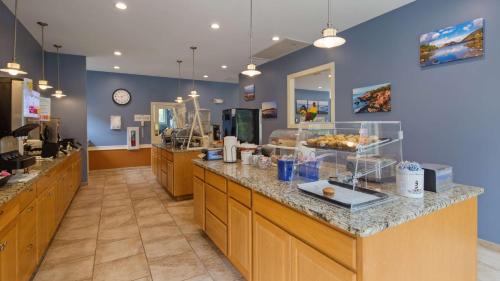 a cafeteria with a counter with food on it at Best Western Acadia Park Inn in Bar Harbor