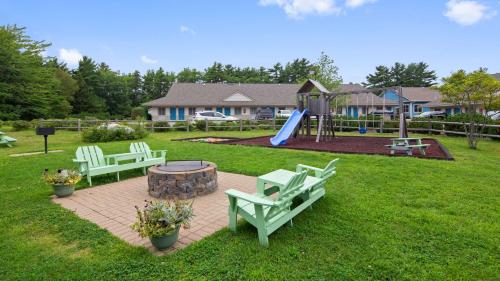 a park with two benches and a playground with a slide at Best Western Acadia Park Inn in Bar Harbor