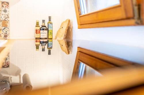 a wall with bottles of wine hanging on a wall at Kranach 5 - Wohnen beim Wein in Gamlitz