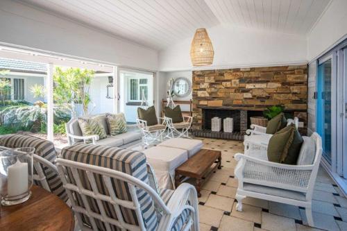 a living room with a couch and a fireplace at Kwa Thibi Cottage Sleeps 14-with inverter in Umdloti