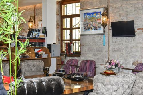 a living room with two chairs and a table at Orchis Hotel in Ayvalık