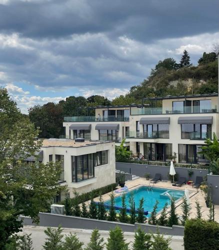 an aerial view of a building with a swimming pool at Buena Vista Villas in Varna City