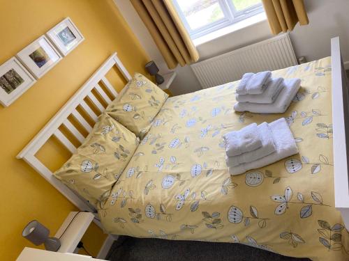 a small bedroom with a bed with towels on it at The Sun B&B Rooms in Winforton