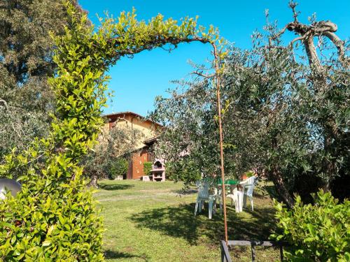 an arch in a garden with an apple tree at Apartment L'Uccelliera-3 by Interhome in Canneto