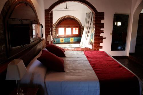 a bedroom with a large bed in a room at Hotel Monasterio de Rocamador in Almendral