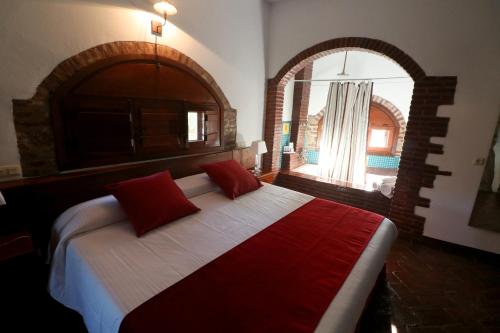 Hotel Monasterio de Rocamador tesisinde bir odada yatak veya yataklar