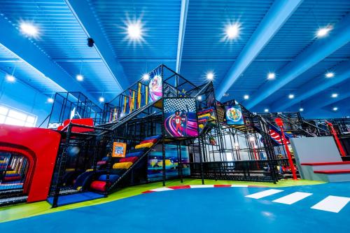 a room with a playground with a slide and slidesktop at RINGRAST das Erlebnishotel beim Red Bull Ring in Spielberg