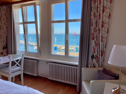 a bedroom with a room with a view of the ocean at Lakeside Apartments Rorschach - easy self check-in in Rorschach