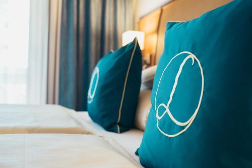 a room with two blue pillows with a hoop on it at Hotel & Spa Larimar in Stegersbach