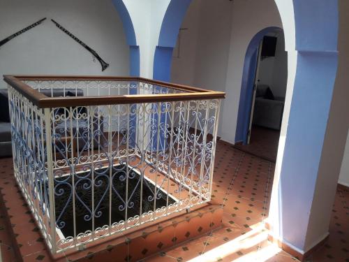 a cage full of wine bottles in a building at Casa El Haouta in Chefchaouene