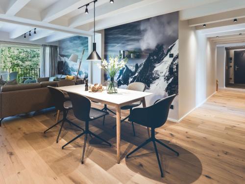 een eetkamer met een tafel en stoelen en een bank bij Apartment Mariandl am Meer-5 by Interhome in Staphel