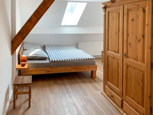 a bedroom with a bed and a wooden cabinet at Apartment Baltrum by Interhome in Westerholt
