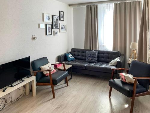 a living room with a couch and chairs and a television at Apartment Parkareal - Utoring-21 by Interhome in Bolgen