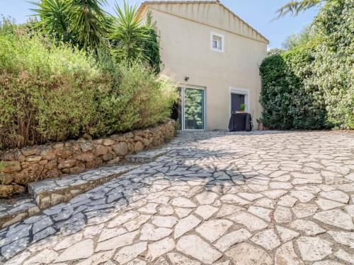 a stone driveway in front of a house at Apartment Les Chevrefeuilles by Interhome in La Valette-du-Var