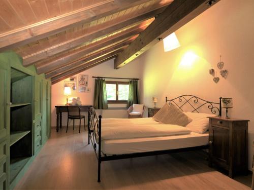 a bedroom with a bed and a desk in a room at Apartment Chesa Seglias 6 by Interhome in Surlej
