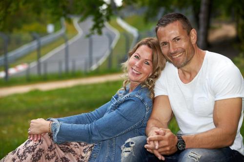 a man and a woman sitting on the grass at Haus Marvin in Döttingen