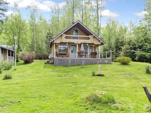 a log cabin in the woods with a yard at Holiday Home Lietukka by Interhome in Outokumpu