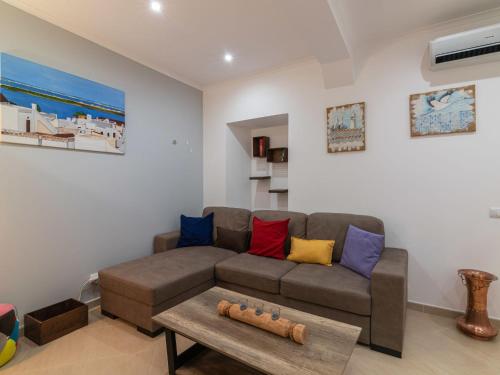 a living room with a couch and a table at Holiday Home Felicidade by Interhome in Olhão